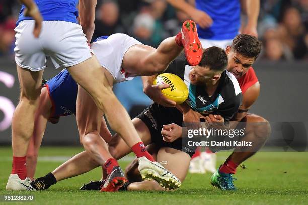 Robbie Gray of the Power is tackled by Neville Jetta of the Demons during the round 14 AFL match between the Port Adelaide Power and the Melbourne...