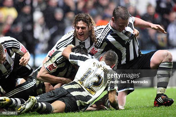 Newcastle players mob Jose Enrique after he scored the second goal during the Coca Cola Championship match between Newcastle United and Nottingham...