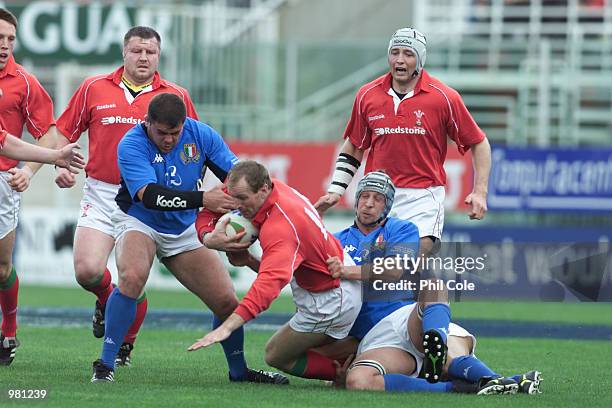 Garth Thomas of Wales gets the defence of of Italy during their win over Italy at the enf of the LLoyds TSB six Nations Championship between Italy...