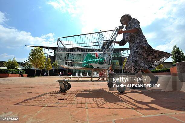 Woman leaves after shopping at Maponya Mall in Soweto on March 19, 2010 This is the new Soweto, a mix of upper-crust comforts and urban grit, where...