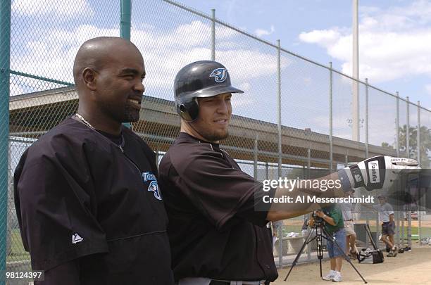 Toronto Blue Jays sluggers Carlos Delgado and Eric Hinske watch practice March 3, 2004 in Dunedin, Florida.