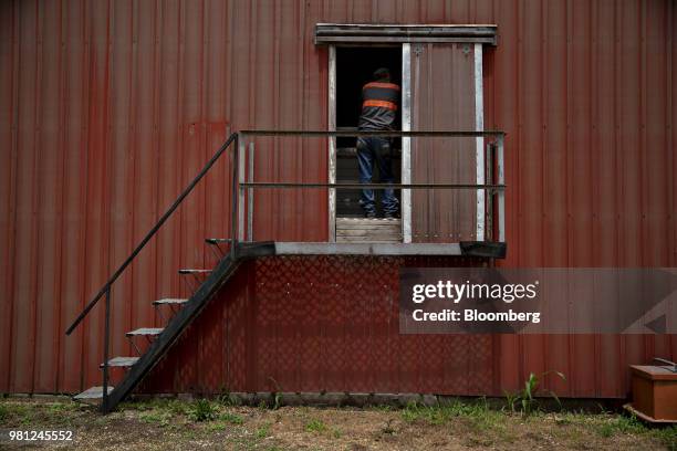 Worker monitors corn being loaded into a truck at a grain elevator in Ohio, Illinois, U.S., on Tuesday, June 19, 2018. A rout in commodities deepened...