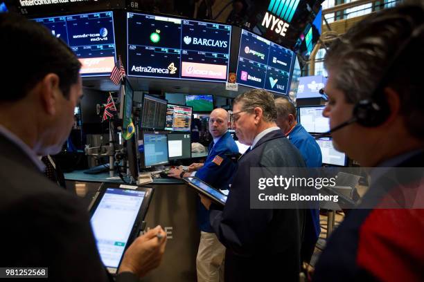 Traders work on the floor of the New York Stock Exchange in New York, U.S., on Friday, June 22, 2018. U.S. Stocks climbed following gains in Europe...