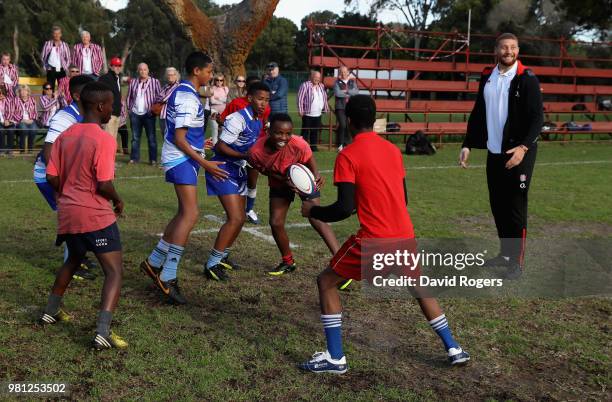 Nick Isiekwe of England looks on as young players pass the ball at the Atlas Foundation coaching clinic held at Rhondebosch Boys High School on June...