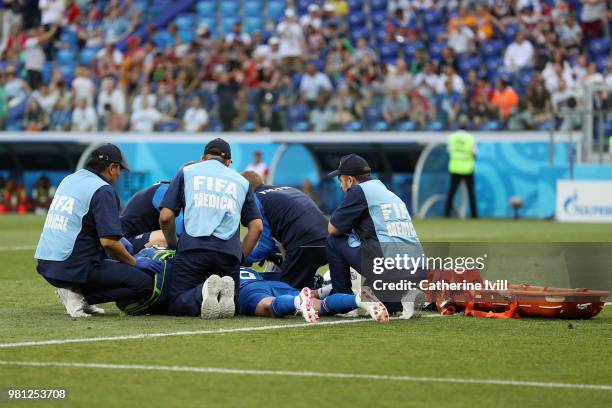 Ragnar Sigurdsson of Iceland receives medical treatment during the 2018 FIFA World Cup Russia group D match between Nigeria and Iceland at Volgograd...