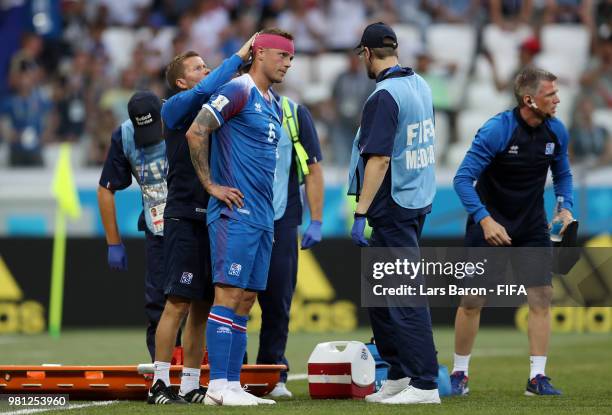 Ragnar Sigurdsson of Iceland receives medical treatment during the 2018 FIFA World Cup Russia group D match between Nigeria and Iceland at Volgograd...