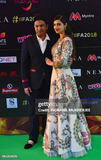 Indian producer Bhushan Kumar poses for a picture with his wife and producer Divya Khosla Kumar arrives for the IIFA Rocks of the 19th International...