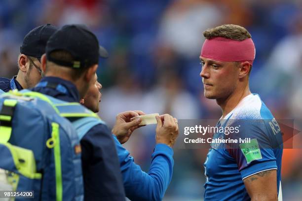 Ragnar Sigurdsson of Iceland receives medical treatment during the 2018 FIFA World Cup Russia group D match between Nigeria and Iceland at Volgograd...