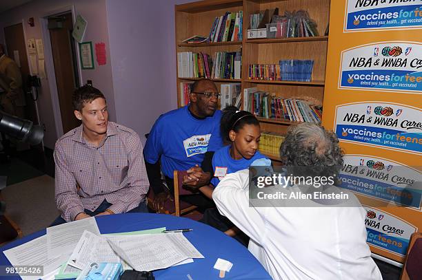 Bob Lanier, NBA legend and Basketball Hall of Framer, and Jonas Jerebko of the Detroit Pistons lend their moral support as a student receives her...