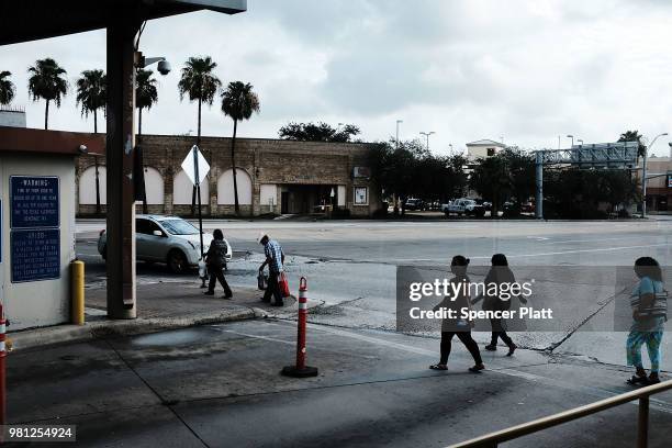 Mexican residents walk into town after making the daily crossing into the American border city of Brownsville, a city which has become dependent on...