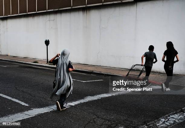 People walk through downtown Brownsville, a border city which has become dependent on the daily crossing into and out of Mexico on June 22, 2018 in...