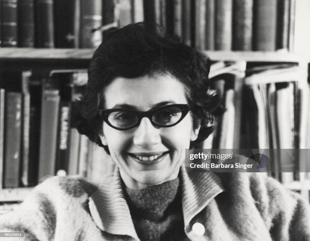 Portrait of woman smiling wearing cat-eye glasses