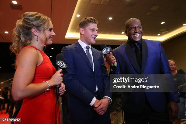 Nathan MacKinnon of the Colorado Avalanche speaks with NHL Network sportscasters Jamie Hersch and Kevin Weekes as MacKinnon arrives at the 2018 NHL...