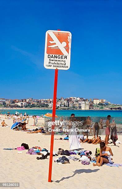 danger sign on crowded beach in sydney, australia - bondi beach sign stock pictures, royalty-free photos & images