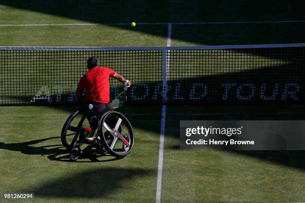 Stephane Houdet of France hits a smash in the men's wheelchair doubles against Alfie Hewett and Gordon Reid of Great Britain during Day 5 of the...