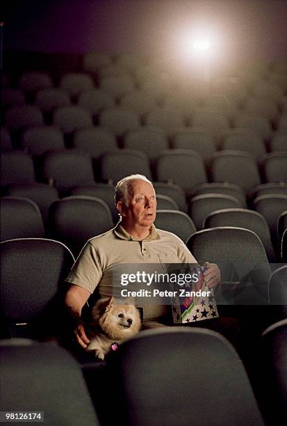 man with dog in movie theater - animal kingdom 2010 film stock pictures, royalty-free photos & images