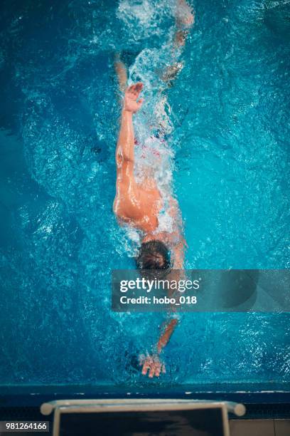 mature adult man swimming - indoor triathlon stock pictures, royalty-free photos & images