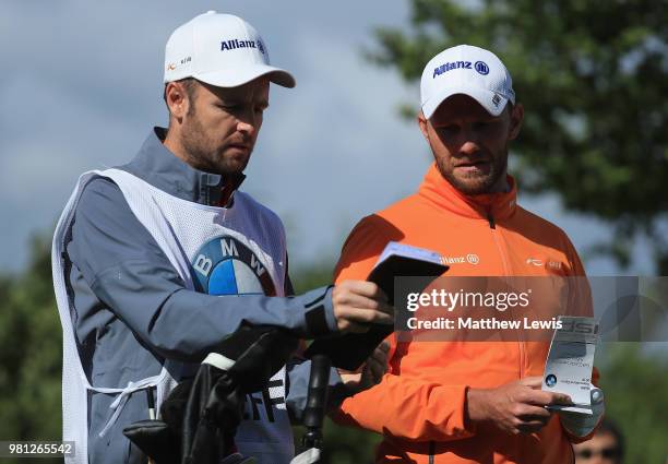 Maximillian Kieffer of Germany looks on with his caddie during day two of the BMW International Open at Golf Club Gut Larchenhof on June 22, 2018 in...