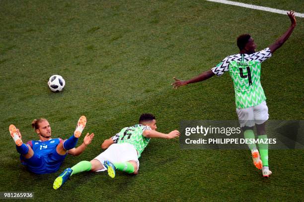 Nigeria's midfielder Onyinye Ndidi reacts as Nigeria's defender Leon Balogun falls with Iceland's midfielder Rurik Gislason during the Russia 2018...