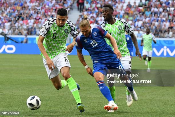 Iceland's midfielder Rurik Gislason vies with Nigeria's defender Leon Balogun and Nigeria's midfielder Onyinye Ndidi during the Russia 2018 World Cup...