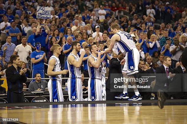 Playoffs: Duke Kyle Singler victorious with teammates Miles Plumlee and Brian Zoubek on bench during game vs Purdue. Houston, TX 3/26/2010 CREDIT:...