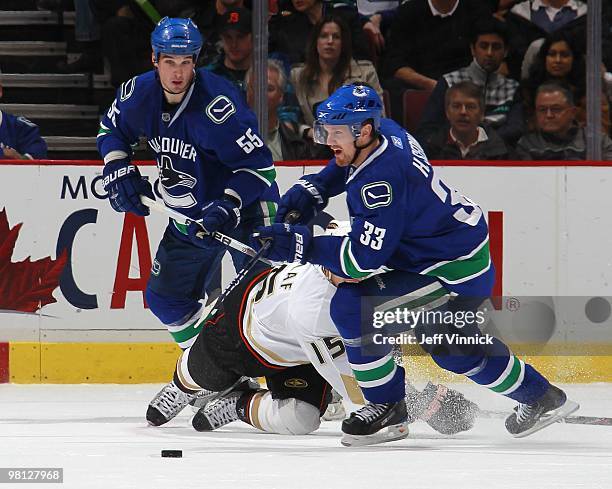 Shane O'Brien of the Vancouver Canucks looks on as teammate Henrik Sedin steals the puck from Ryan Getzlaf of the Anaheim Ducks during their game at...