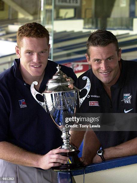 Justin Leppitsch the Brisbane Lions vice-captain and Matthew Primus the Port Power captain with the Ansett Cup at a press conference for the Ansett...