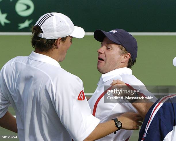 Bob Bryan and captain Patrick McEnroe celebrate as the United States clinches victory at Family Circle Tennis Center in the 2004 David Cup semifinal...