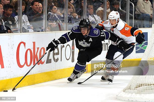 Anze Kopitar of the Los Angeles Kings skates with the puck against Bruno Gervais of the New York Islanders at Staples Center on March 20, 2010 in Los...