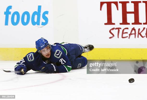 Mason Raymond of the Vancouver Canucks looks at the loose puck after falling during their game against the Calgary Flames at General Motors Place on...