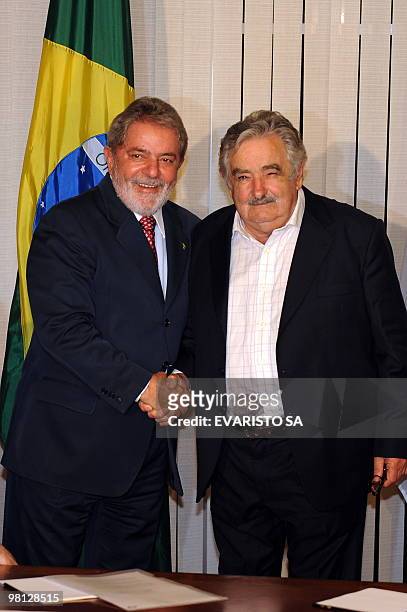 Brazilian President Luiz Inacio Lula da Silva and Uruguay's President Jose Mujica shake hands during a meeting at Itamaraty Palace in Brasilia, on...