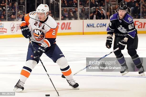 Mark Streit of the New York Islanders handles the puck while Scott Parse of the Los Angeles Kings looks on at Staples Center on March 20, 2010 in Los...