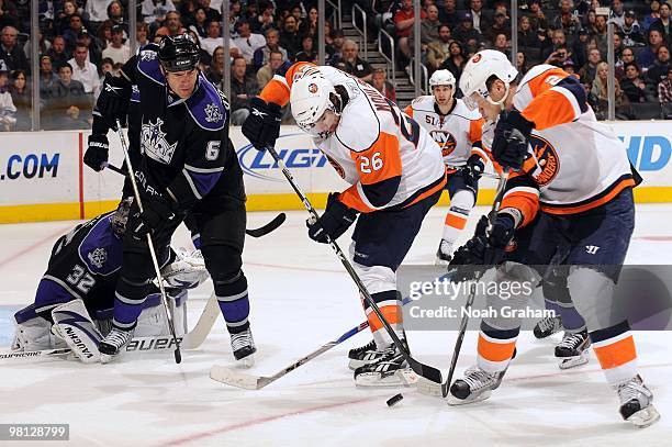 Matt Moulson and Mark Streit of the New York Islanders reach for the puck against Sean O'Donnell of the Los Angeles Kings at Staples Center on March...