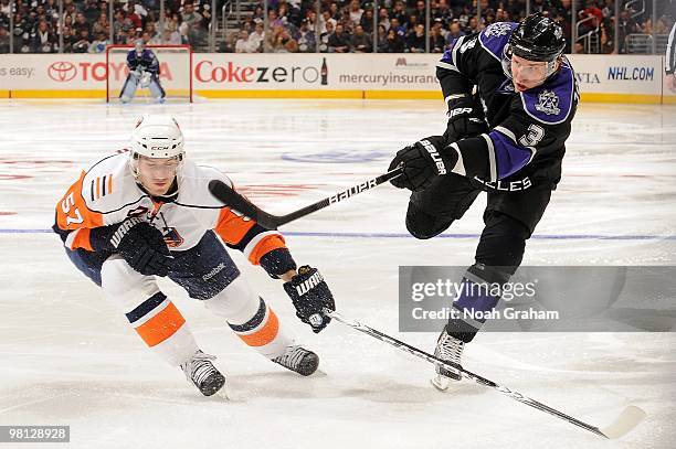 Jack Johnson of the Los Angeles Kings shoots against Blake Comeau of the New York Islanders at Staples Center on March 20, 2010 in Los Angeles,...