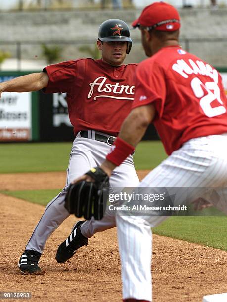 Houston Astros infielder Chris Burke slides into third base against the Philadelphia Phillies in a spring training game March 7, 2005 in Clearwater,...