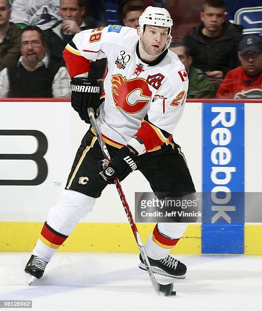 Robyn Regehr of the Calgary Flames skates up ice with the puck during their game against the Vancouver Canucks at General Motors Place on March 14,...