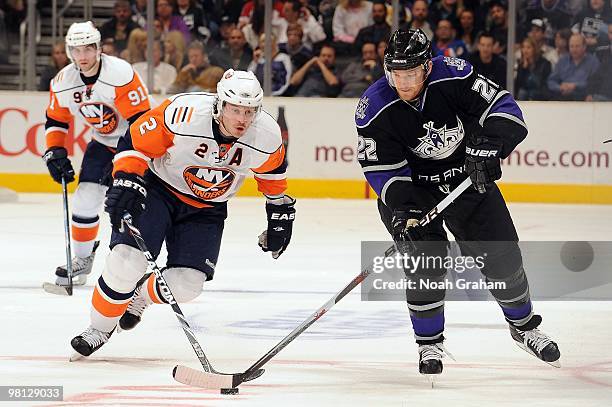 Jeff Halpern of the Los Angeles Kings skate against Mark Streit of the New York Islanders at Staples Center on March 20, 2010 in Los Angeles,...