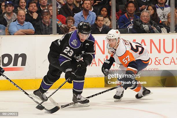 Dustin Brown of the Los Angeles Kings skates with the puck against Blake Comeau of the New York Islanders at Staples Center on March 20, 2010 in Los...