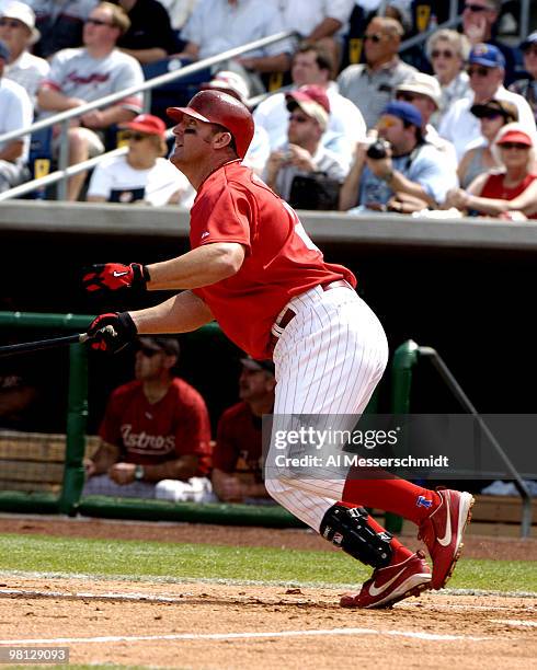 Philadelphia Phillies first baseman Jim Thome follows through ona home-run swing against the Houston Astros in a spring training game March 7, 2005...