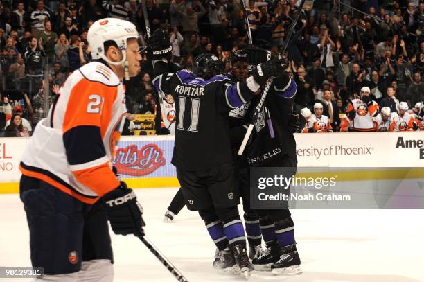 Anze Kopitar and Wayne Simmonds of the Los Angeles Kings come together while Mark Streit of the New York Islanders skates following their game at...