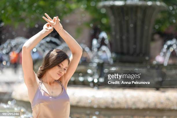 young teenager girl posing in front of fountain, sofia, bulgaria - anna pekunova stock-fotos und bilder