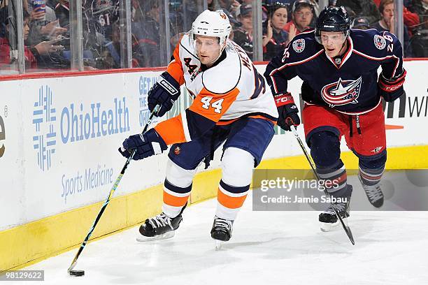 Defenseman Freddy Meyer of the New York Islanders skates with the puck against forward Samuel Pahlsson of the Columbus Blue Jackets on March 27, 2010...