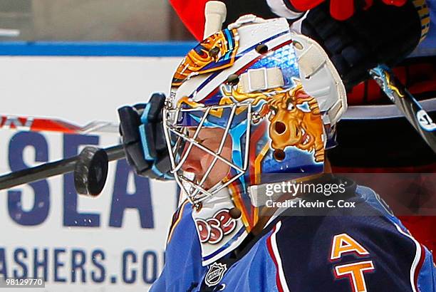 Goaltender Johan Hedberg of the Atlanta Thrashers saves a shot on goal by the Carolina Hurricanes at Philips Arena on March 29, 2010 in Atlanta,...