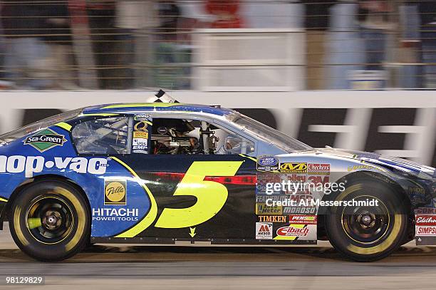 Kyle Busch does a victory lap with the checkered flag hanging out his window after winning the Sharpie Mini 300 NASCAR Busch Series race at Bristol...