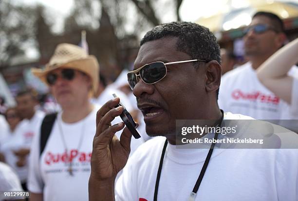 Man speaks into his cell phone on The Mall March 21, 2010 during a Immigration Reform Rally in Washington, DC. Cell phone subscribers in the US...