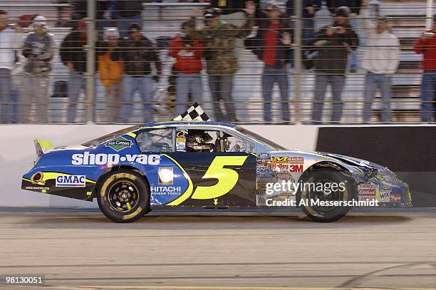 Kyle Busch does a victory lap with the checkered flag hanging out his window after winning the Sharpie Mini 300 NASCAR Busch Series race at Bristol...