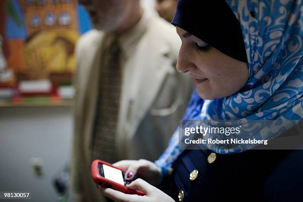 Linda Sarsour, the Director of the Arab-American Association of New York, sends a text message on a cell phone March 19, 2010 in Brooklyn, New York....