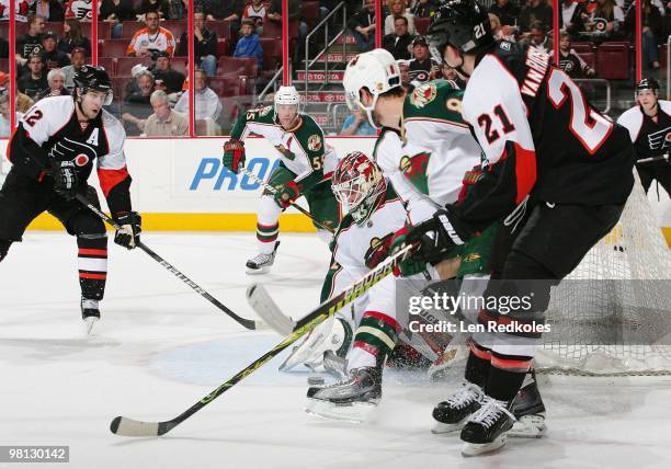 Simon Gagne and James van Riemsdyk of the Philadelphia Flyers take a shot on goal against Nick Schultz, Niklas Backstrom and Brent Burns of the...