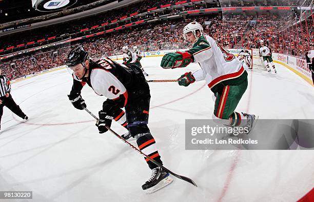 Lukas Krajicek of the Philadelphia Flyers is being check by Nick Schultz of the Minnesota Wild on March 25, 2010 at the Wachovia Center in...