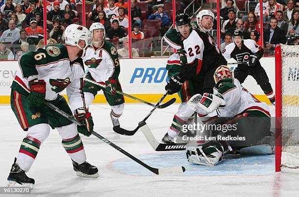 Ville Leino of the Philadelphia Flyers takes a shot on goal against Greg Zanon, Nick Schultz and Nicklas Backstrom of the Minnesota Wild on March 25,...